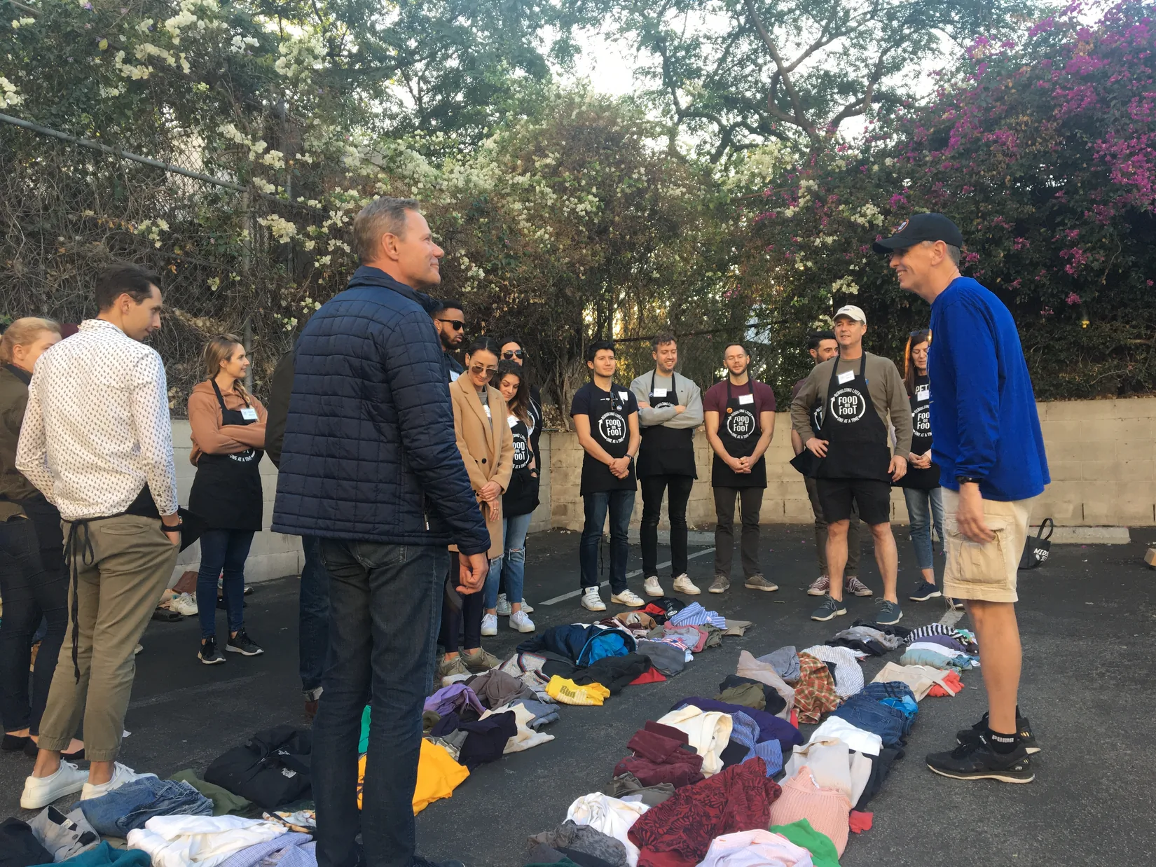 People volunteering around piles of clothing at a community-service event in November 2019